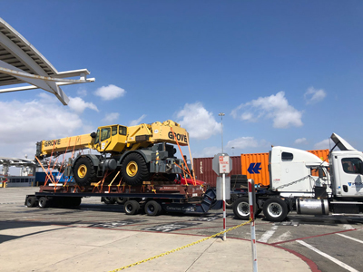 Export Logistics & Shipping, Inc. transports Grove RT760 crane by 18-wheeler truck